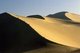 China: A camel train on the sand dunes of Mingsha Shan (Mingsha Hills) in the Kumtagh Desert, Gansu Province